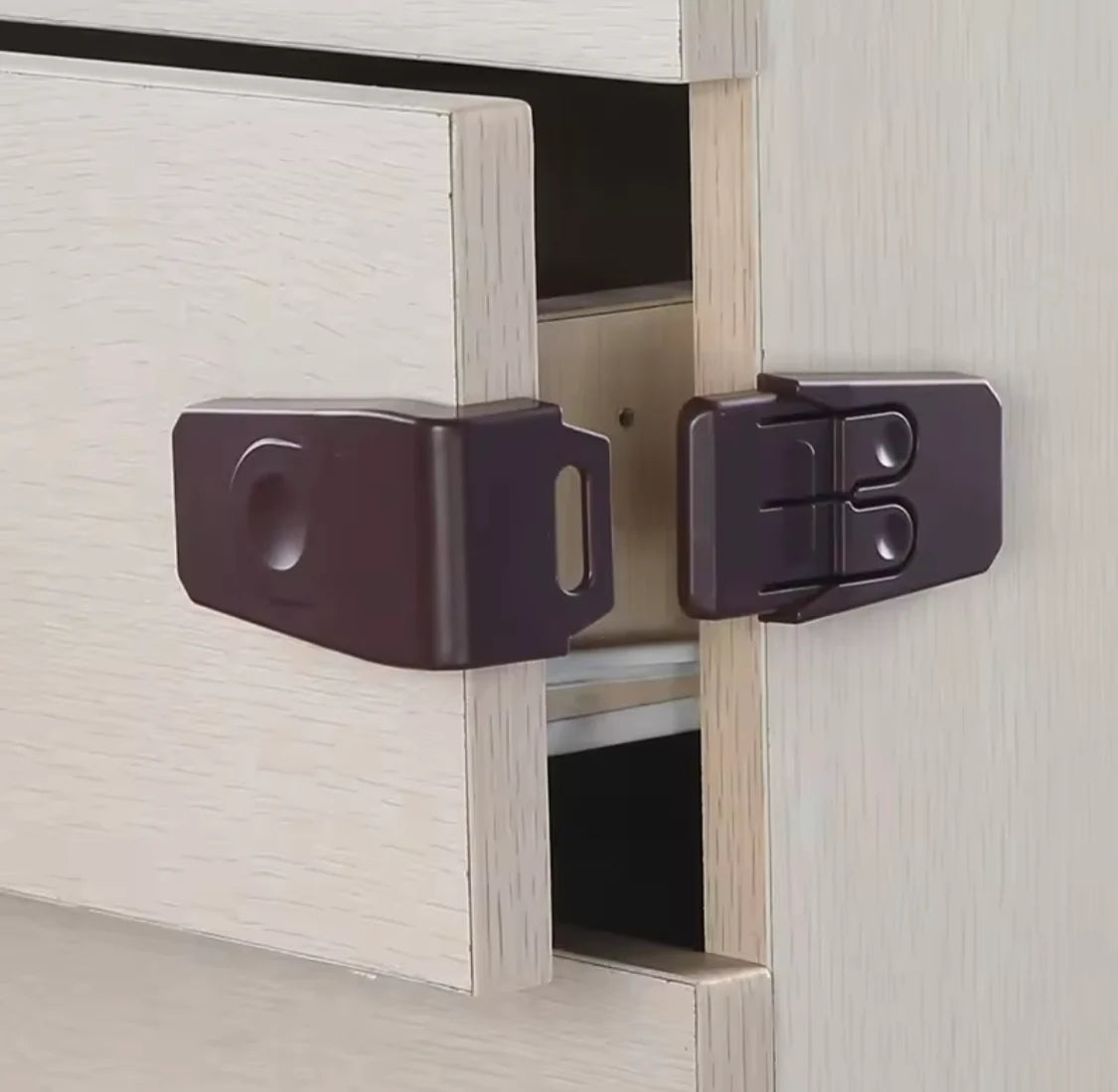 Pair of cabinet door locks on a wooden cabinet with a neutral background
